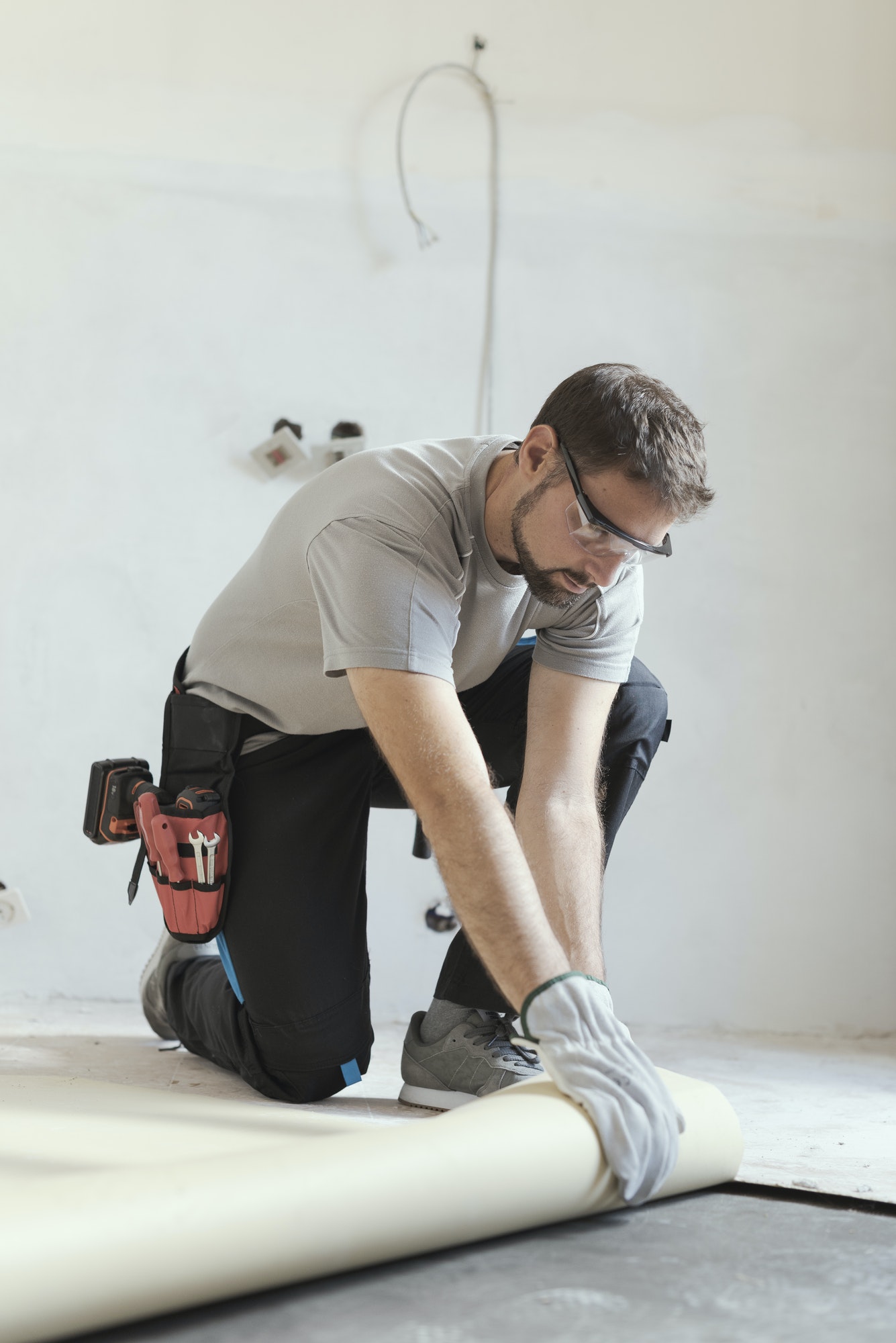 Worker install's vinyl plank floors