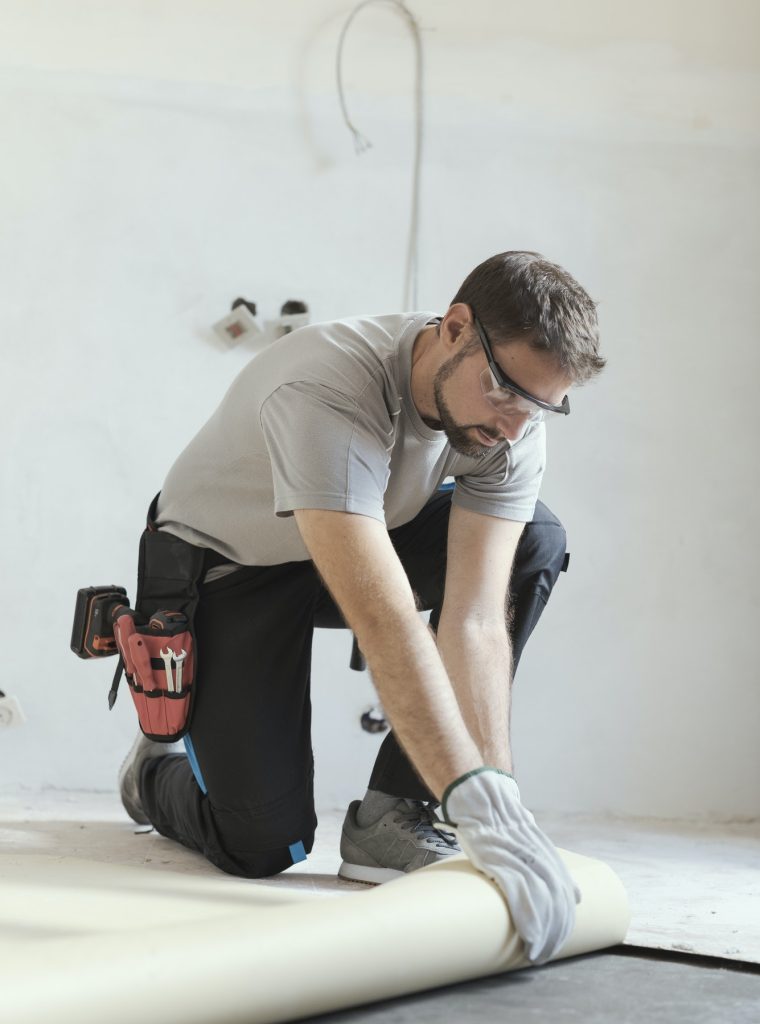 Worker install's vinyl plank floors